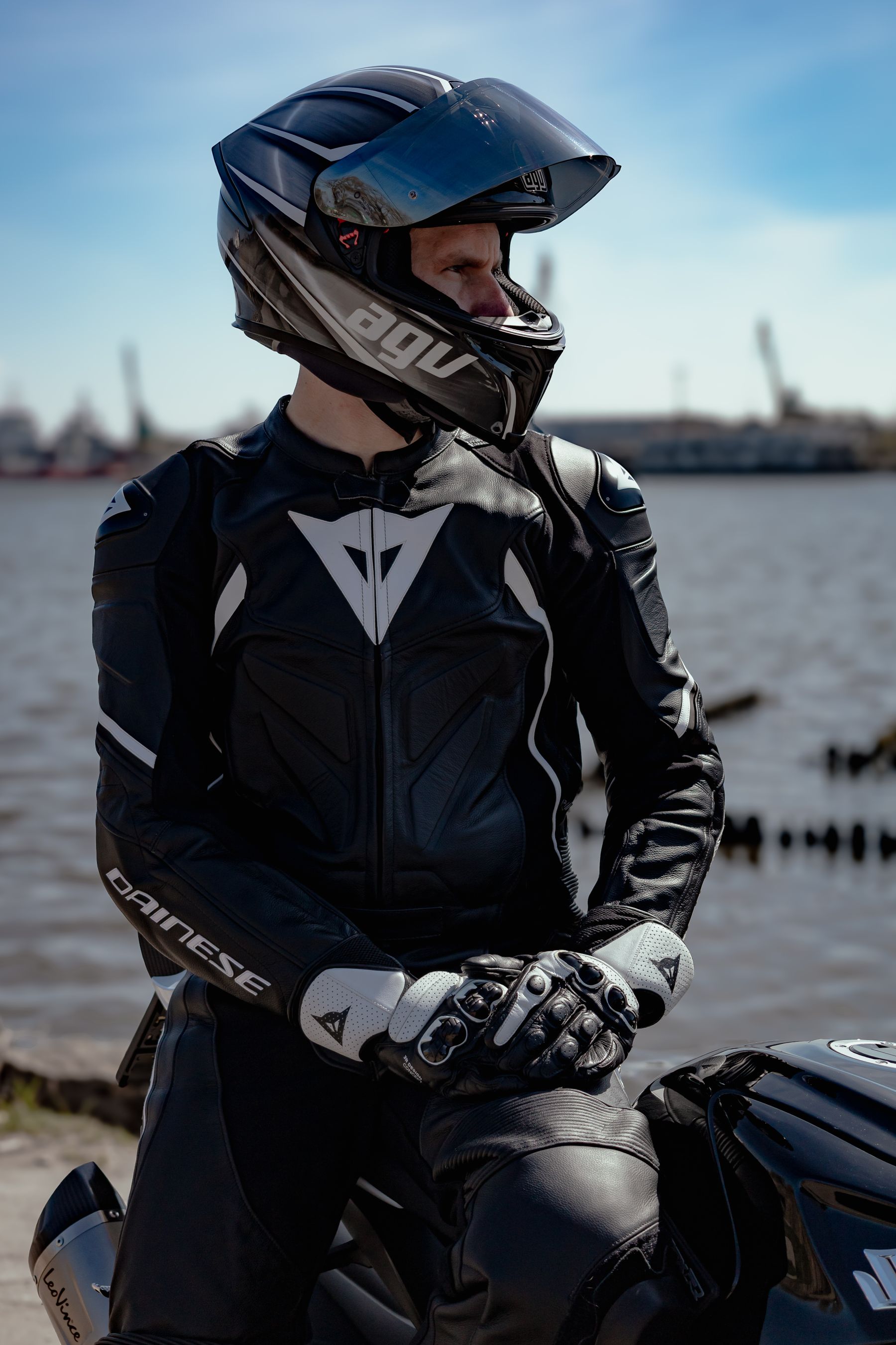 Rider in leathers checking over a motorcycle